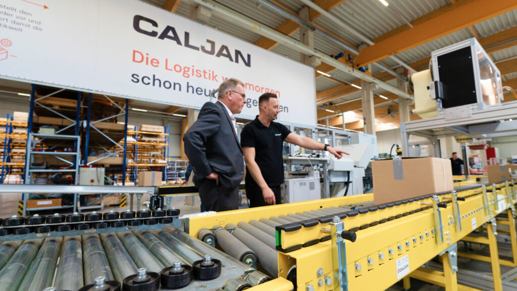 two persons viewing Caljan labelling solution in Caljan Demo Centre in Halle