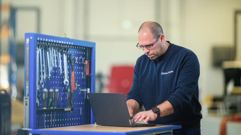 A Caljan employee reviewing System Insights data about Caljan equipment
