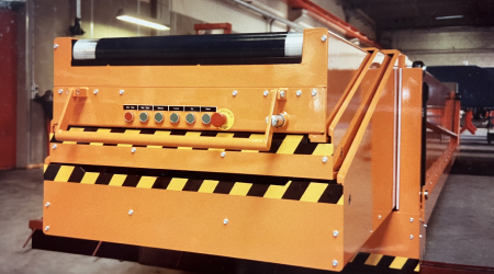 Old orange Caljan Conveyor in a retracted position